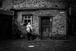 Woman looking in window, Monschau, Germany (2015)